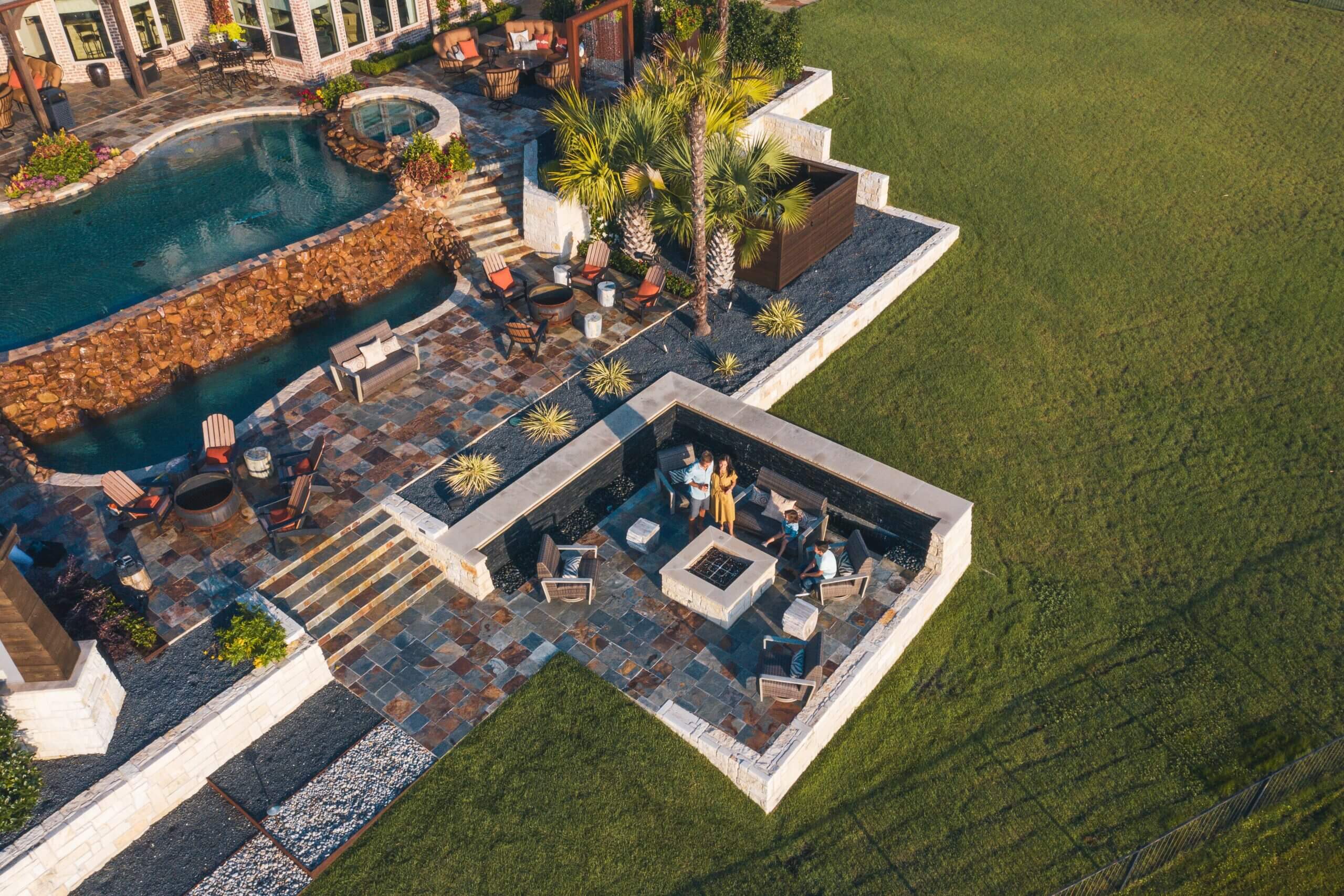 Overhead view of outdoor area with fire pit, seating areas, and pool