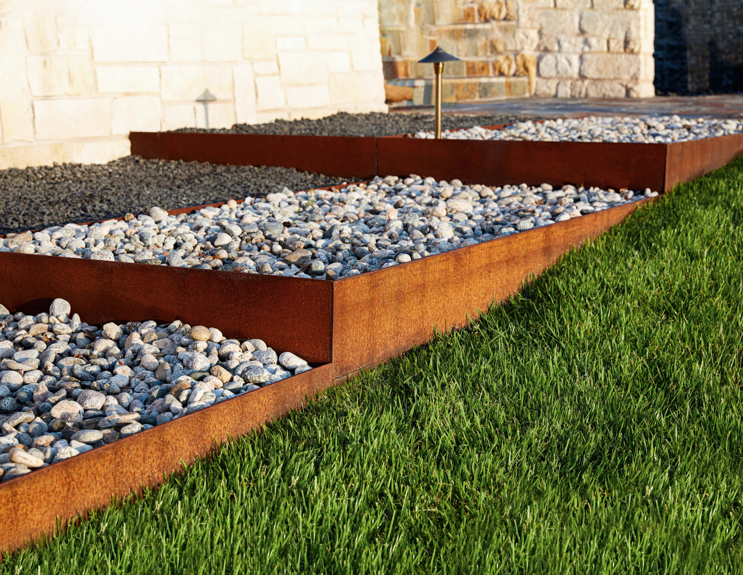 Custom Steel Edging between rocks and grass