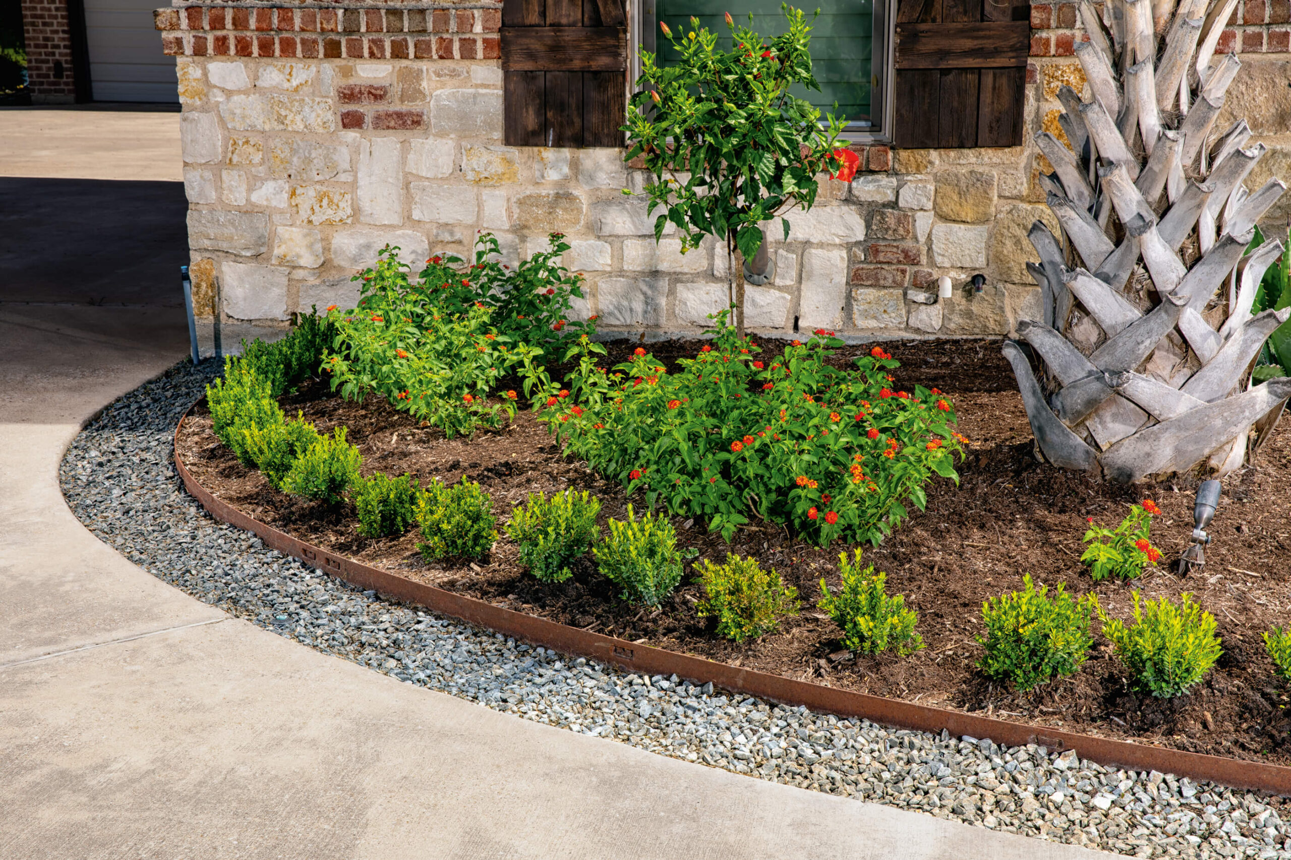 Classic Steel Edging between a garden and rock border of a stone pathway