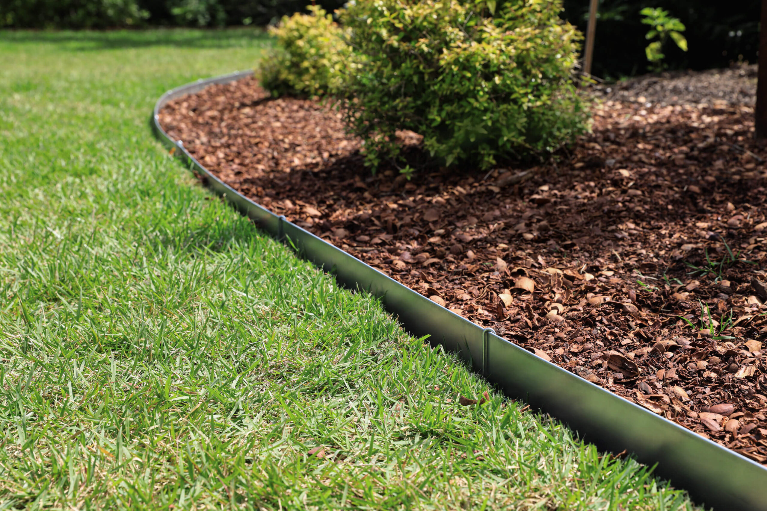 place and pin steel edging between mulch and grass