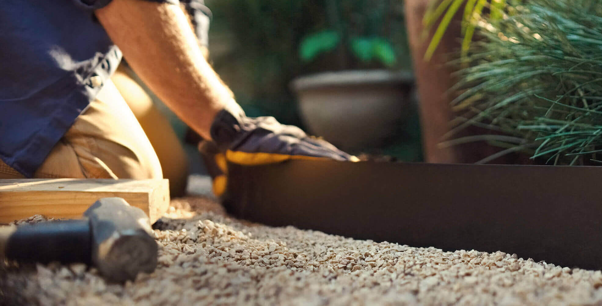 person placing QuickLock steel edging